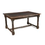 An oak refectory table of traditional style, circa 1900 with quatrefoil decoration to the capital
