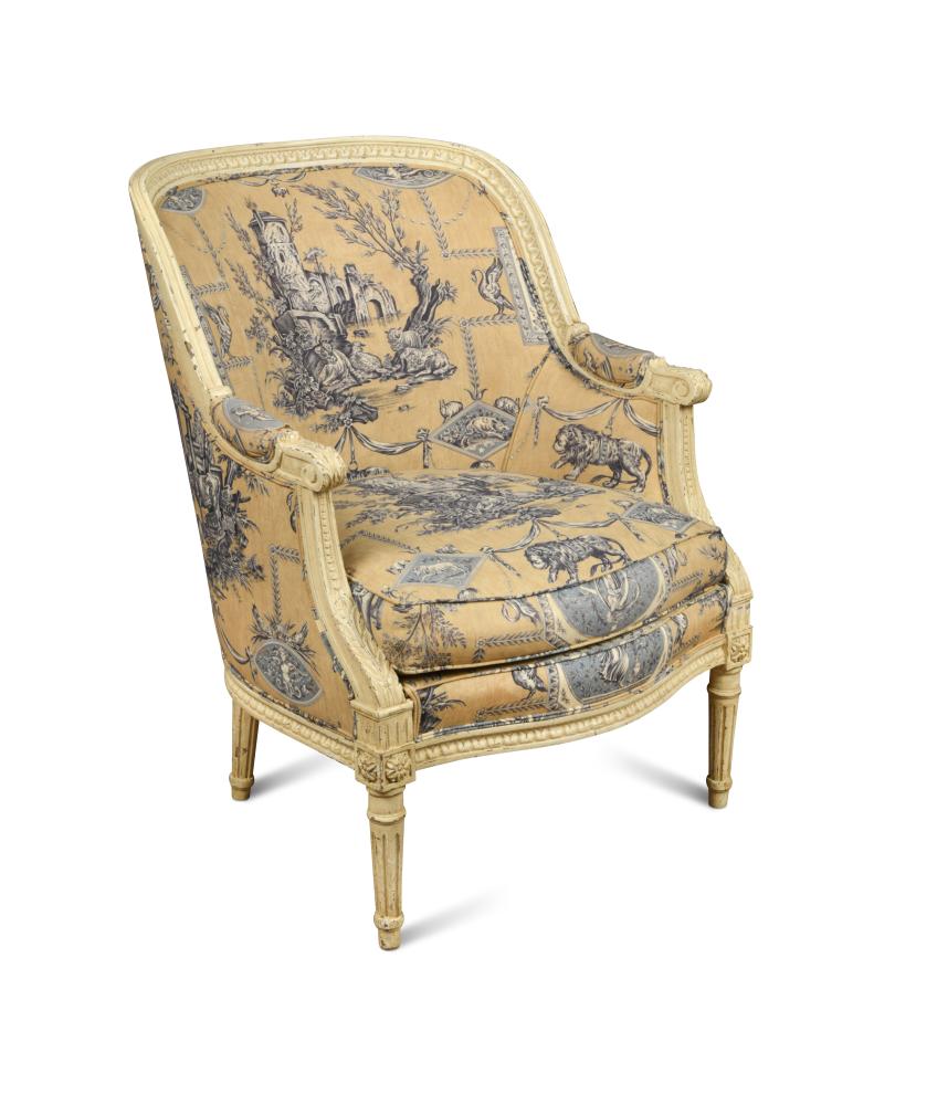 A French Louis XVI revival tub armchair, the painted and leaf carved frame upholstered in a blue and