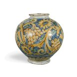 A 17th century Italian maiolica globular vase, decorated in yellow, green and blue with fruiting