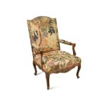 A Louis XIV style carved walnut armchair, 19th century, upholstered in verdure tapestry108 108 x