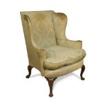 A George II style wing back armchair, on cabriole legs and pad feet 101 x 91cm (39 x 35in)