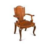 A George III Irish mahogany armchair, with paper scroll carved back, dished panel seat, on shell and