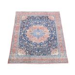 A large Tabriz carpet, of traditional design, with a central medallion on a blue ground 500 x
