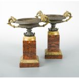 A pair of Regency bronze and marble tazza, each bowl with gilt bronze scroll handles to a gilt