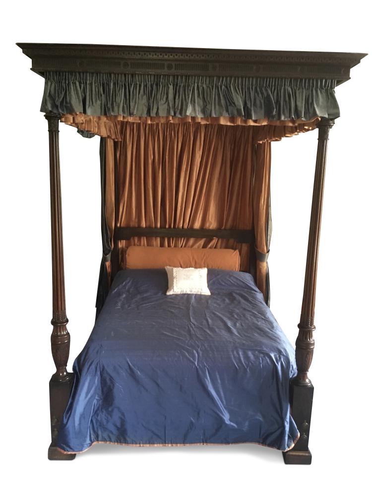 A George III and later mahogany four post bed, of traditional design, with leaf carved and gadroon