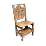 An 18th century Italian carved walnut prie dieu chair, the back decorated with scrolls, leaves and