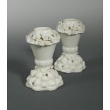 A rare pair of Saint-Cloud blanc de chine pot-pourri vases, circa 1730-50, the quarter lobed