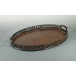 A George III style figured mahogany oval two handled tray, with pierced gallery and inset handles 59