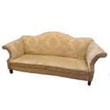 A George III style mahogany framed sofa, with shaped back and scroll arms, upholstered in a yellow