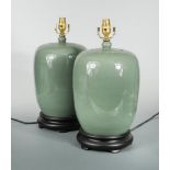 A pair of modern celadon glaze table lamps, of baluster jar and cover form to hardwood bases (2)