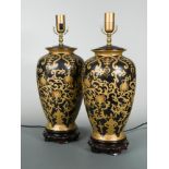 A large pair of modern table lamps, of inverted baluster form decorated with gilt scroll work to a