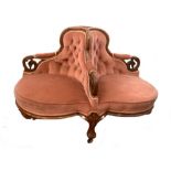 A mid-Victorian walnut framed conversation seat, circa 1870, on leaf carved feet and casters 88 x