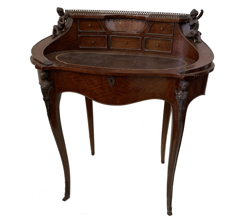 A Transitional style kingwood bureau de dame with cast metal mounts and leather inset oval writing