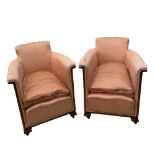 A pair of Edwardian tub armchairs, upholstered in pink silk, on leaf carved feet, 73cm (29in) high x