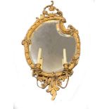 A 19th century gilt gesso framed girandole with two sconces, 103 x 54cm (40.5 x 21in)