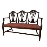 An Edwardian mahogany chair back settee in the Hepplewhite tradition, 97cm (38in) high x 141cm (55.