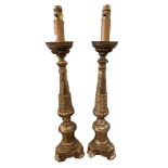 A pair of Continental carved giltwood pricket candlestick lamps, with crenellated tin plate drip