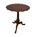 A mid Victorian figured walnut tripod occasional table with escalloped edge, on a fluted column,