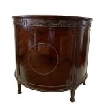 An Edwardian mahogany demi-lune commode, carved with Neoclassical swag decoration to the frieze,