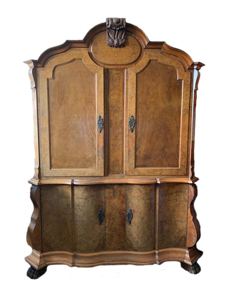 A 19th century Dutch walnut armoire, with leaf carved cresting and mirror veneered panels, 232 x 176