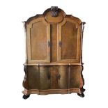 A 19th century Dutch walnut armoire, with leaf carved cresting and mirror veneered panels, 232 x 176