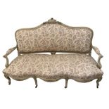 A French painted salon suite carved with foliate show wood, comprising; a sofa, 112 x 177cm (44 x