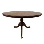 A Regency mahogany circular pedestal centre table, with a crossbanded top and reeded border, on a