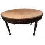 An Edwardian 'Adam' revival mahogany oval centre table, with urn and swag carved frieze, on square