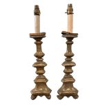 A pair of Continental carved gilt wood pricket candlesticks, with crenellated tin plate drip pans,