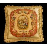 A pair of late 18th century Gobelin tapestry faced silk cushions, decorated with a figure and dog to