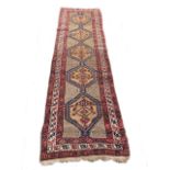 A Persian camel ground runner in the Kazak tradition within three minor borders, 334 x 102cm (131.
