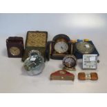 A collection of small clocks including an example by Zenith in a presentation case, a miniature