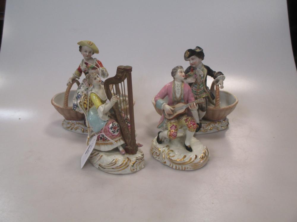 A pair of Dresden figural bonbonieres with figures sitting on baskets and two continental musical