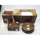 A George III mahogany cube shaped tea caddy, a Regency rosewood sarcophagus tea caddy, a