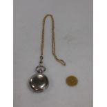 A Victorian sovereign in a white metal sovereign case, suspended from a 9ct belcher link chain,