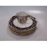 A set of seven Royal Crown Derby plates, decorated in 18th century style together with a cup