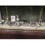 A large collection of silverplated items including a three piece tea set, coffee pot, entree dish,