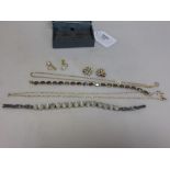 A small collection of jewellery to include a hallmarked 9ct gold chain, a moonstone line bracelet,