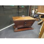 A Regency mahogany rectangular wine cooler, with raised cover, on carved lionpaw feet and plinth