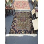 A modern Bokhara rug with ivory ground and a 20th century Persian silk rug with blue ground (2)