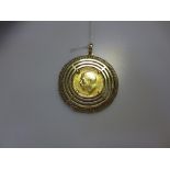 A pendant of concentric rings claw set with a George V sovereign dated 1920, 19.7g gross