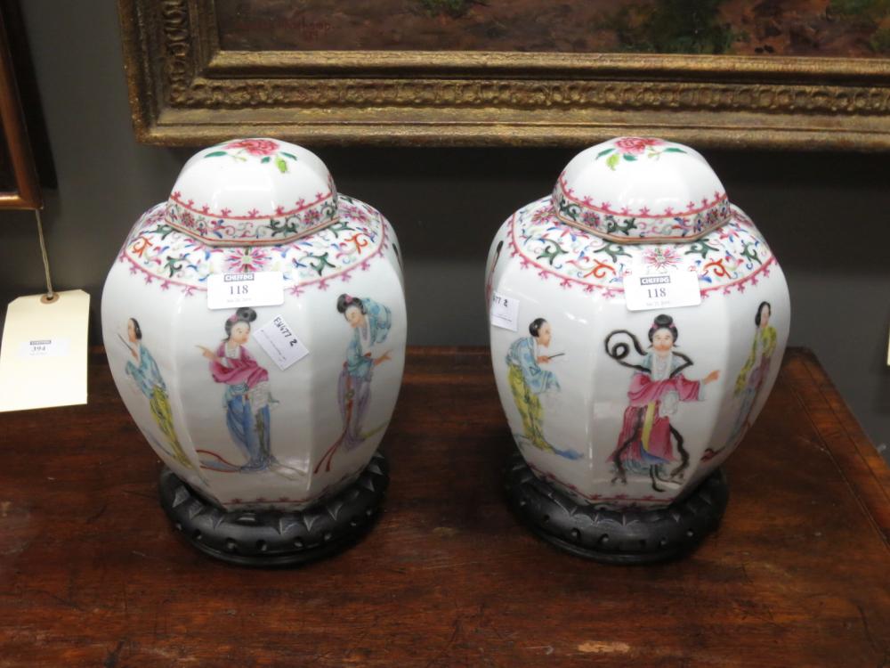A pair of 20th Century famille rose octagonal jars and covers