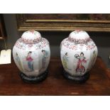 A pair of 20th Century famille rose octagonal jars and covers