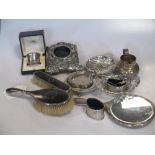 A collection of silverware including flatware, three small dishes, a small cream jug, a cased napkin