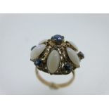 An opal and sapphire flowerhead cluster ring, stamped '14k'