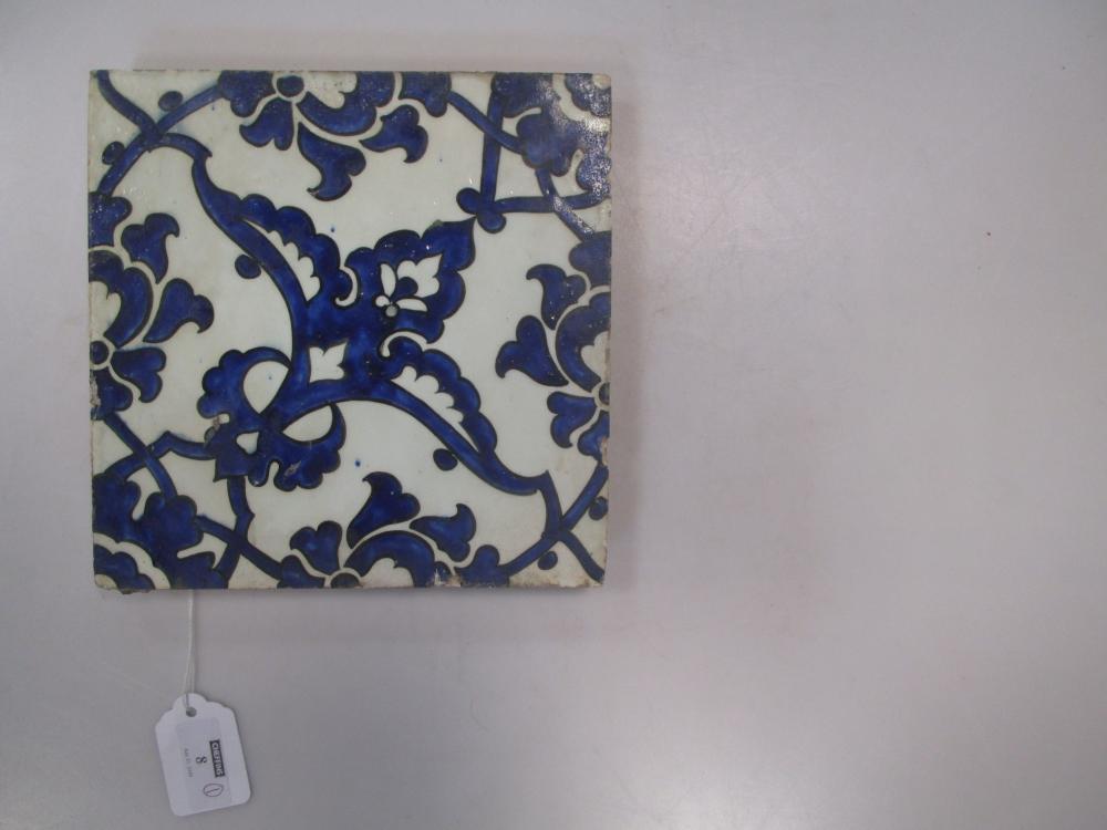 A mid 16th century Iznik 'Dome of the Rock' tile, painted in blue on the diagonal with wing shaped