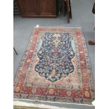 A Tabriz rug, with florals on a blue ground (worn in places), 200 x 134cm