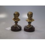 A pair of French gilt bronze busts depicting a laughing child and a crying child 10.5cm high (2)