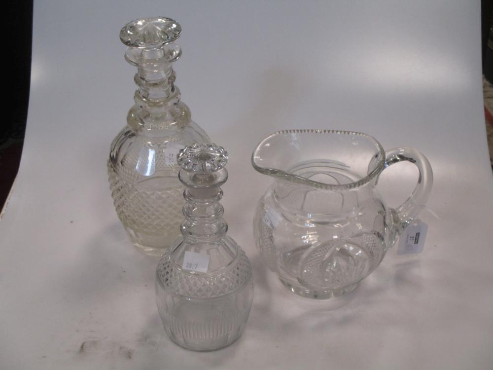 A pair of 19th century cut class decanters, of baluster form, the stoppers of segmented stoppers