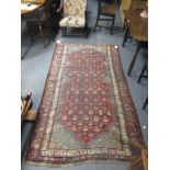 A Caucasian red ground rug, 223 x 124cm